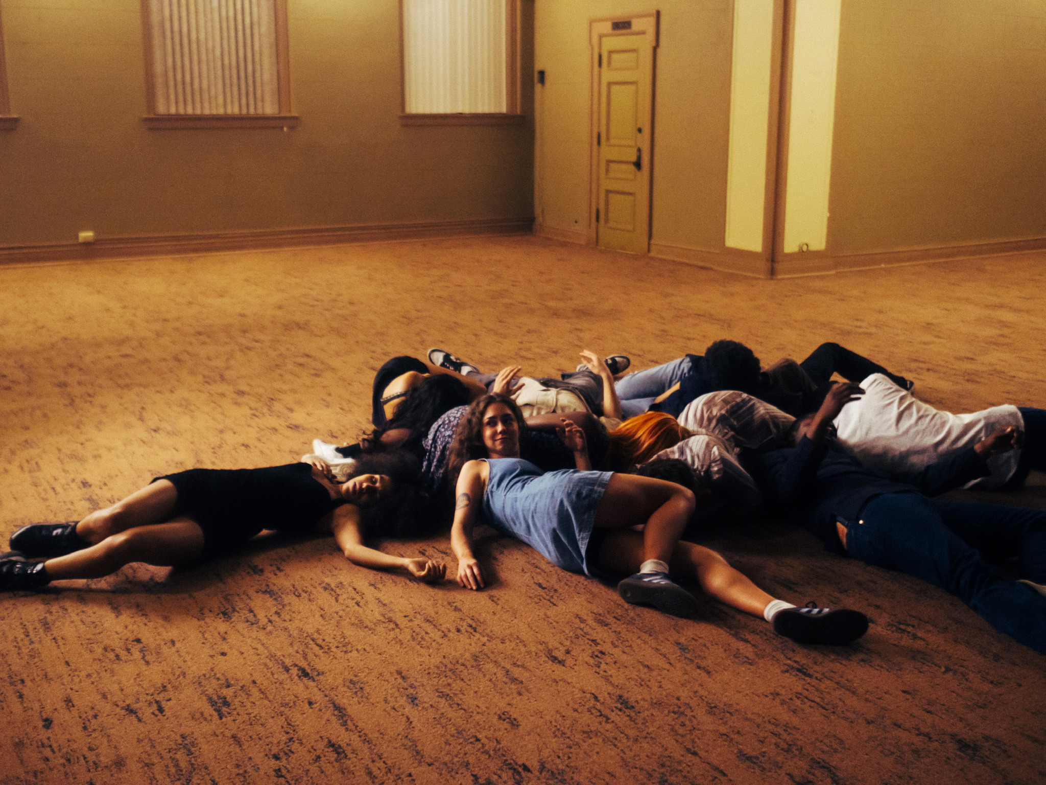 Dancers collapsed together on the ballroom floor between takes